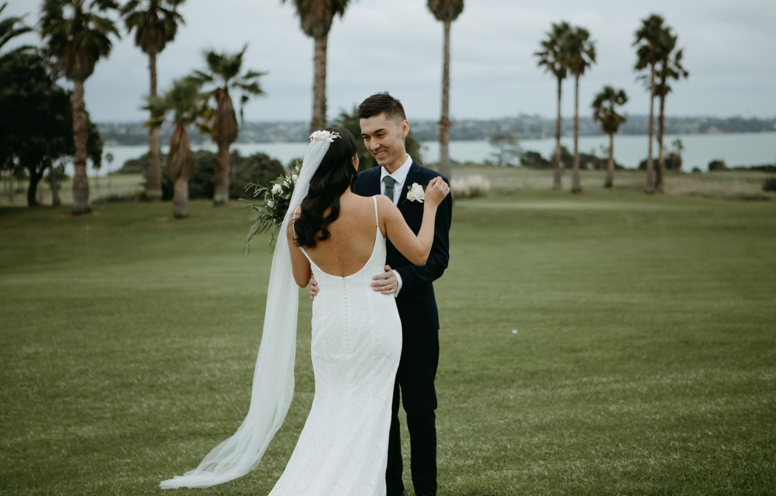 Bride and groom on lawns at Rydges Formosa